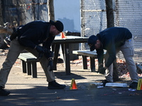 Evidence markers indicate where blood and other evidence is found after a 21-year-old man is fatally stabbed at Steuben Park in Brooklyn, Ne...