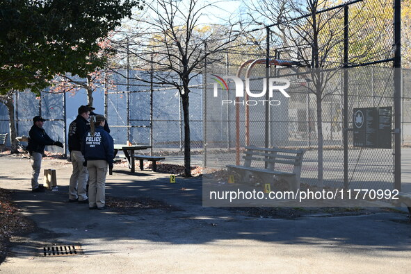 Evidence markers indicate where blood and other evidence is found after a 21-year-old man is fatally stabbed at Steuben Park in Brooklyn, Ne...