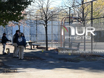 Evidence markers indicate where blood and other evidence is found after a 21-year-old man is fatally stabbed at Steuben Park in Brooklyn, Ne...