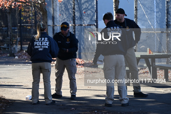 Evidence markers indicate where blood and other evidence is found after a 21-year-old man is fatally stabbed at Steuben Park in Brooklyn, Ne...