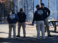 Evidence markers indicate where blood and other evidence is found after a 21-year-old man is fatally stabbed at Steuben Park in Brooklyn, Ne...