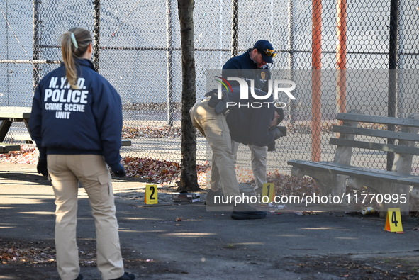 Evidence markers indicate where blood and other evidence is found after a 21-year-old man is fatally stabbed at Steuben Park in Brooklyn, Ne...