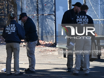 Evidence markers indicate where blood and other evidence is found after a 21-year-old man is fatally stabbed at Steuben Park in Brooklyn, Ne...