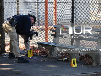 Evidence markers indicate where blood and other evidence is found after a 21-year-old man is fatally stabbed at Steuben Park in Brooklyn, Ne...