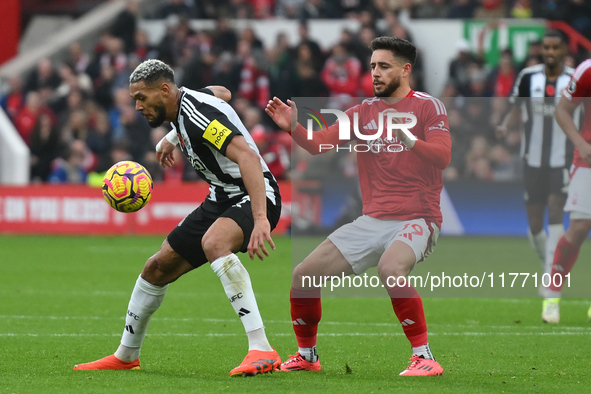 Joelinton of Newcastle United is under pressure from Alex Moreno of Nottingham Forest during the Premier League match between Nottingham For...