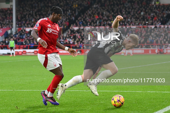 Anthony Elanga of Nottingham Forest puts pressure on Lewis Hall of Newcastle United during the Premier League match between Nottingham Fores...