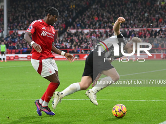 Anthony Elanga of Nottingham Forest puts pressure on Lewis Hall of Newcastle United during the Premier League match between Nottingham Fores...