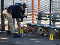 Evidence markers indicate where blood and other evidence is found after a 21-year-old man is fatally stabbed at Steuben Park in Brooklyn, Ne...