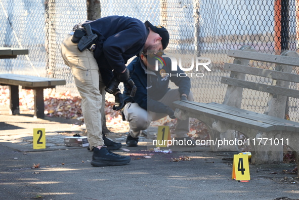 Evidence markers indicate where blood and other evidence is found after a 21-year-old man is fatally stabbed at Steuben Park in Brooklyn, Ne...