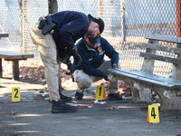 Evidence markers indicate where blood and other evidence is found after a 21-year-old man is fatally stabbed at Steuben Park in Brooklyn, Ne...