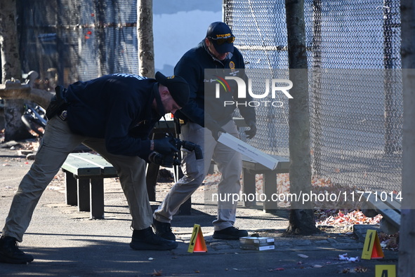 Evidence markers indicate where blood and other evidence is found after a 21-year-old man is fatally stabbed at Steuben Park in Brooklyn, Ne...