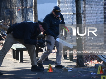 Evidence markers indicate where blood and other evidence is found after a 21-year-old man is fatally stabbed at Steuben Park in Brooklyn, Ne...