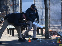 Evidence markers indicate where blood and other evidence is found after a 21-year-old man is fatally stabbed at Steuben Park in Brooklyn, Ne...