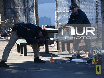 Evidence markers indicate where blood and other evidence is found after a 21-year-old man is fatally stabbed at Steuben Park in Brooklyn, Ne...