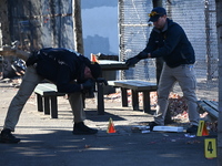 Evidence markers indicate where blood and other evidence is found after a 21-year-old man is fatally stabbed at Steuben Park in Brooklyn, Ne...