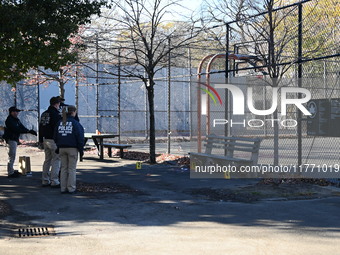 Evidence markers indicate where blood and other evidence is found after a 21-year-old man is fatally stabbed at Steuben Park in Brooklyn, Ne...