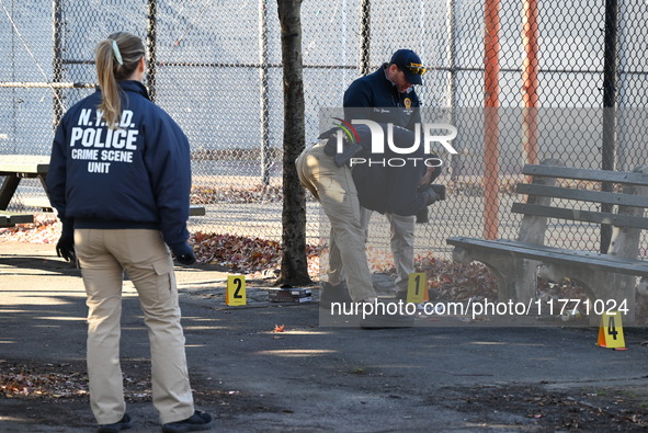 Evidence markers indicate where blood and other evidence is found after a 21-year-old man is fatally stabbed at Steuben Park in Brooklyn, Ne...