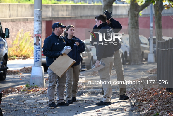 Evidence markers indicate where blood and other evidence is found after a 21-year-old man is fatally stabbed at Steuben Park in Brooklyn, Ne...