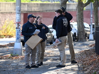 Evidence markers indicate where blood and other evidence is found after a 21-year-old man is fatally stabbed at Steuben Park in Brooklyn, Ne...