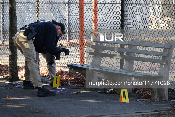 Evidence markers indicate where blood and other evidence is found after a 21-year-old man is fatally stabbed at Steuben Park in Brooklyn, Ne...