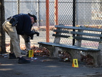 Evidence markers indicate where blood and other evidence is found after a 21-year-old man is fatally stabbed at Steuben Park in Brooklyn, Ne...