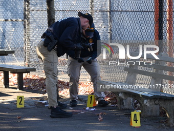 Evidence markers indicate where blood and other evidence is found after a 21-year-old man is fatally stabbed at Steuben Park in Brooklyn, Ne...