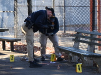 Evidence markers indicate where blood and other evidence is found after a 21-year-old man is fatally stabbed at Steuben Park in Brooklyn, Ne...