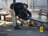 Evidence markers indicate where blood and other evidence is found after a 21-year-old man is fatally stabbed at Steuben Park in Brooklyn, Ne...