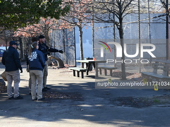 Evidence markers indicate where blood and other evidence is found after a 21-year-old man is fatally stabbed at Steuben Park in Brooklyn, Ne...