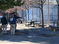 Evidence markers indicate where blood and other evidence is found after a 21-year-old man is fatally stabbed at Steuben Park in Brooklyn, Ne...