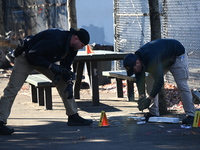 Evidence markers indicate where blood and other evidence is found after a 21-year-old man is fatally stabbed at Steuben Park in Brooklyn, Ne...