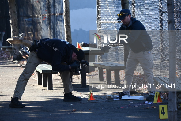 Evidence markers indicate where blood and other evidence is found after a 21-year-old man is fatally stabbed at Steuben Park in Brooklyn, Ne...