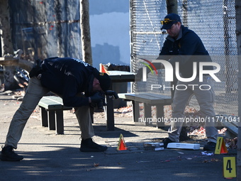 Evidence markers indicate where blood and other evidence is found after a 21-year-old man is fatally stabbed at Steuben Park in Brooklyn, Ne...