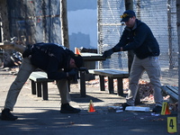 Evidence markers indicate where blood and other evidence is found after a 21-year-old man is fatally stabbed at Steuben Park in Brooklyn, Ne...