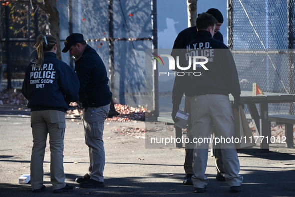 Evidence markers indicate where blood and other evidence is found after a 21-year-old man is fatally stabbed at Steuben Park in Brooklyn, Ne...