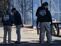 Evidence markers indicate where blood and other evidence is found after a 21-year-old man is fatally stabbed at Steuben Park in Brooklyn, Ne...