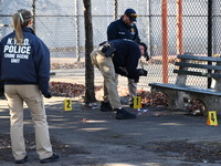 Evidence markers indicate where blood and other evidence is found after a 21-year-old man is fatally stabbed at Steuben Park in Brooklyn, Ne...