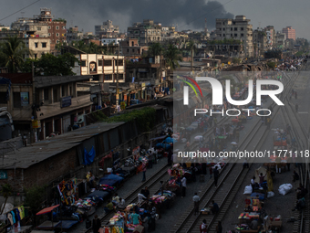 Aerial view shows smoke rising from a burning shoe factory in a densely populated residential area of Dhaka, Bangladesh, on November 12, 202...