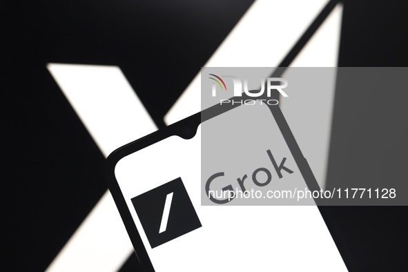 The Grok logo appears on the screen of a smartphone, and in the background, the xAI logo is on the computer screen in Reno, United States, o...