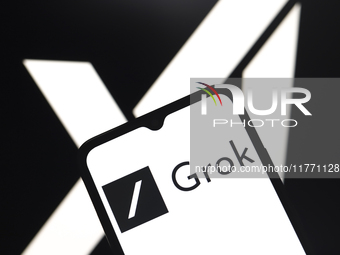 The Grok logo appears on the screen of a smartphone, and in the background, the xAI logo is on the computer screen in Reno, United States, o...