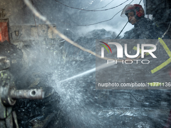 A firefighter works to extinguish flames at a burning shoe factory in a densely populated area of Dhaka, Bangladesh, on November 12, 2024. T...