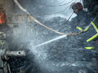 A firefighter works to extinguish flames at a burning shoe factory in a densely populated area of Dhaka, Bangladesh, on November 12, 2024. T...