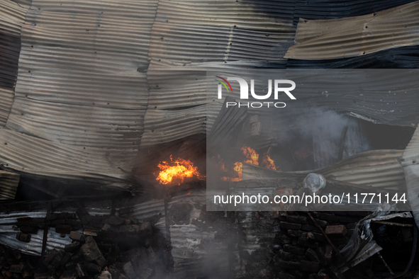 Aerial view shows smoke rising from a burning shoe factory in a densely populated residential area of Dhaka, Bangladesh, on November 12, 202...