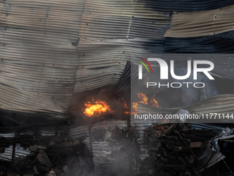 Aerial view shows smoke rising from a burning shoe factory in a densely populated residential area of Dhaka, Bangladesh, on November 12, 202...