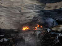 Aerial view shows smoke rising from a burning shoe factory in a densely populated residential area of Dhaka, Bangladesh, on November 12, 202...