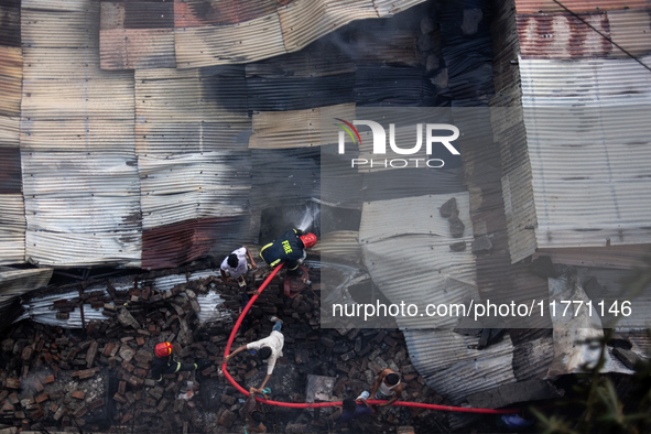 A shoe factory burns in a fire in a densely populated residential area in Dhaka, Bangladesh, on November 12, 2024. The blaze damages the fac...