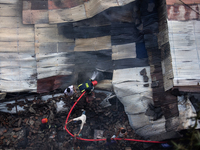 A shoe factory burns in a fire in a densely populated residential area in Dhaka, Bangladesh, on November 12, 2024. The blaze damages the fac...