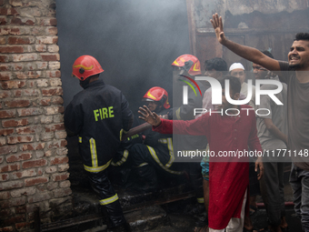 A shoe factory burns in a fire in a densely populated residential area in Dhaka, Bangladesh, on November 12, 2024. The blaze damages the fac...