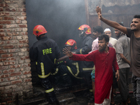 A shoe factory burns in a fire in a densely populated residential area in Dhaka, Bangladesh, on November 12, 2024. The blaze damages the fac...