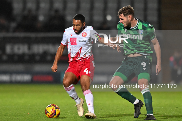 Nathan Thompson (4, Stevenage) is challenged by Josh Andrews (9, Gillingham) during the EFL Trophy match between Stevenage and Gillingham at...